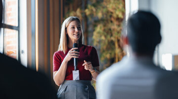 Confident Speaker Presenting to Engaged Audience