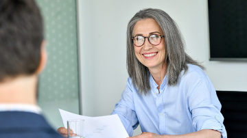 Mature business woman talking to a man