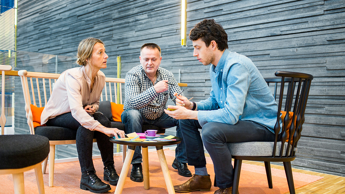 Group of business people sitting at a table talking