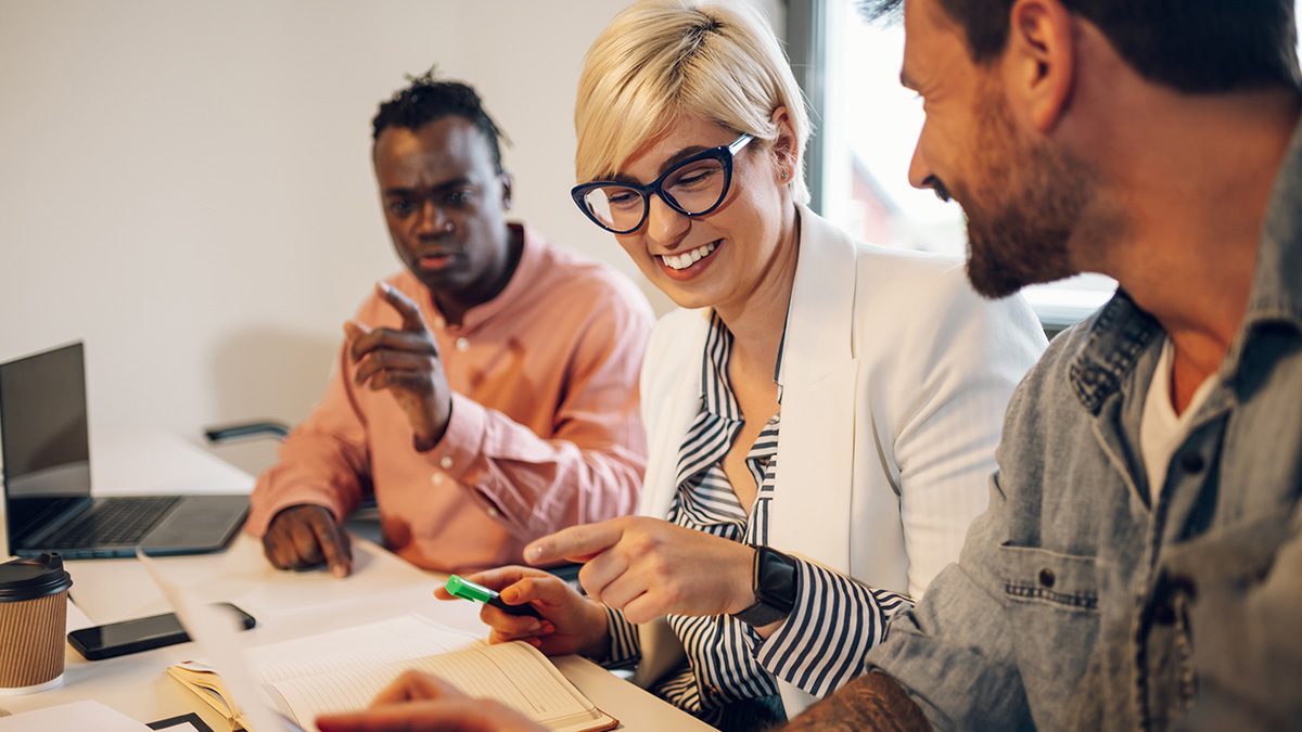 Group of business people sitting at a table talking