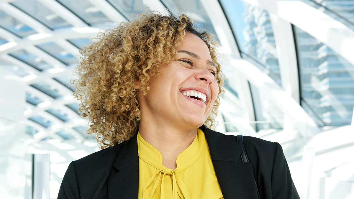 Happy businesswoman with tighly curled hair