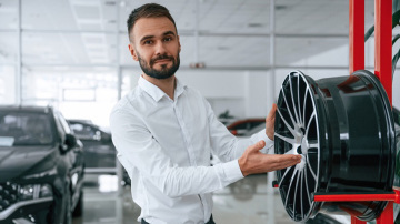 Salesperson with a car tyre