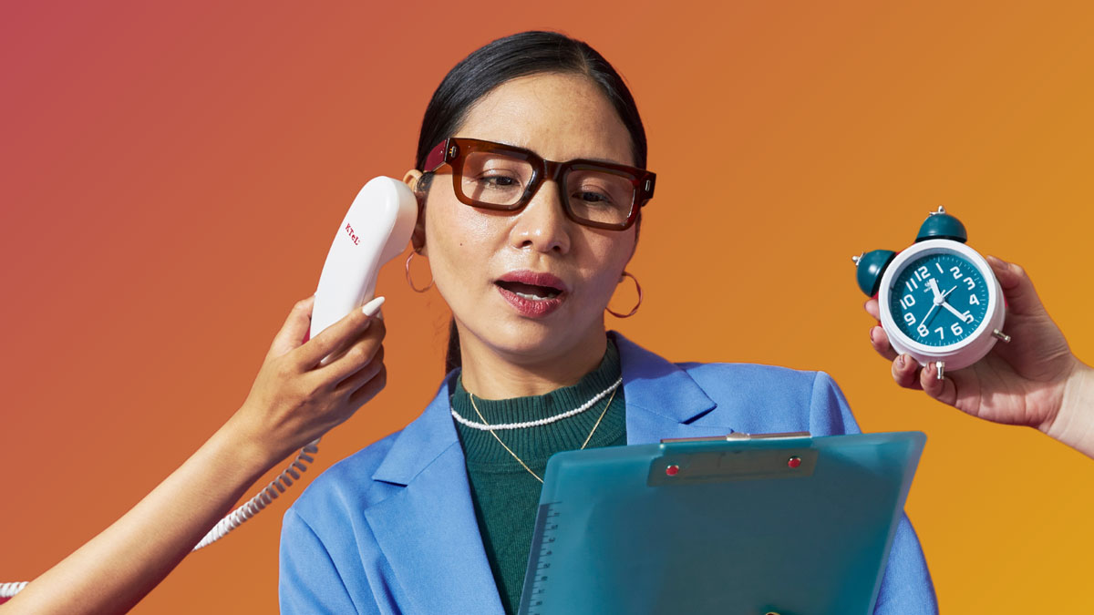 A stressed business woman holding a clipboard and hands from off screen holding out a phone and an alarm clock