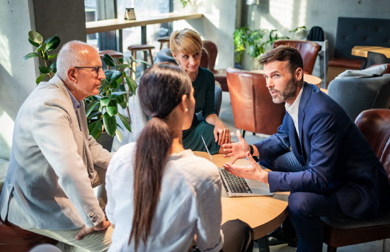 Group of business people listening to a business man